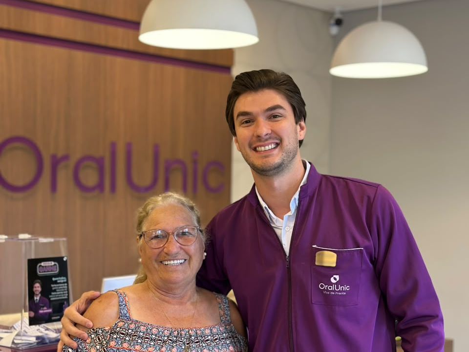 Dr. Matheus Fachim ao lado de um paciente na recepção da Oral Unic Caçador